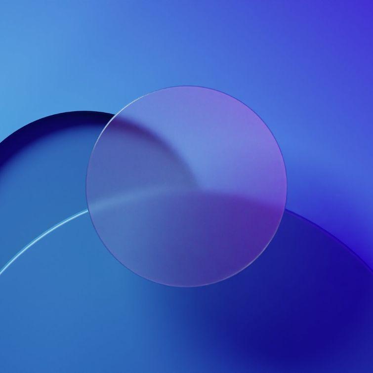 An abstract blue background with a circular object in the middle, disaligned with other circles.